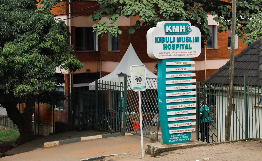 Sign for Kibuli Muslim Hospital in Uganda, listing various medical services.