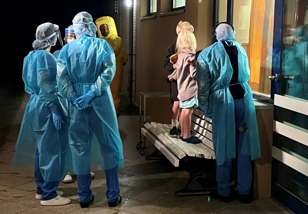 Two children of an American Ebola patient look through a window at their father in the isolation ward at the Charite hospital in Berlin.