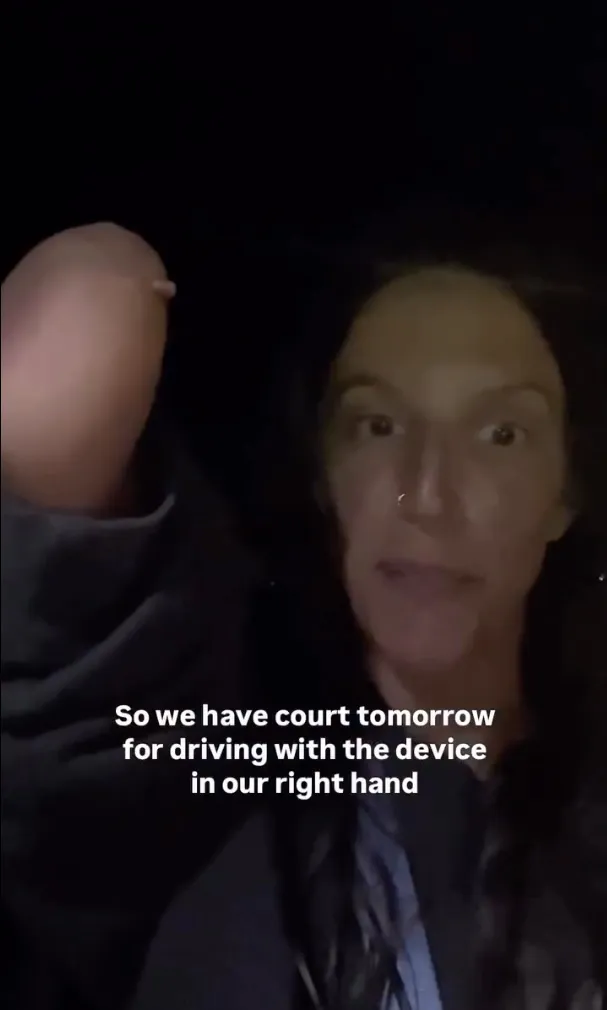 Woman wearing a nose ring talking about having court for driving with a device in her right hand.