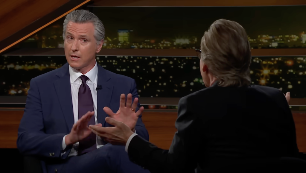 Gavin Newsom in an interview, gesturing with his hands.