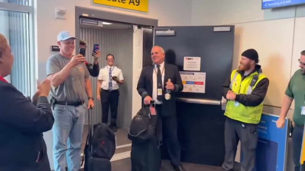 Spirit Airlines Capt. Jon Jackson is greeted by staff and passengers at Baltimore-Washington International on May 2, 2026.