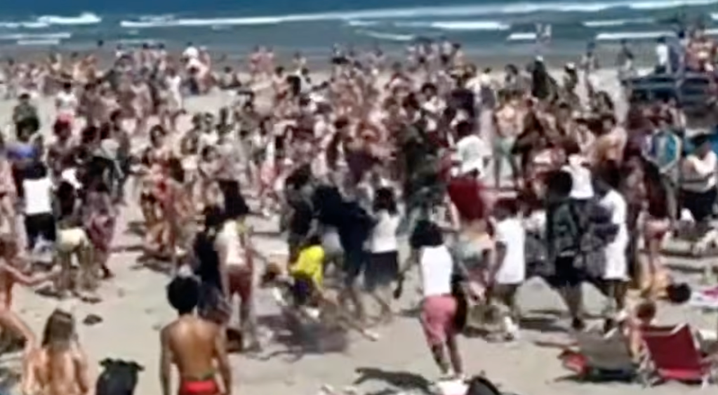 A fight breaks out as hundreds of teens swarmed the Narragansett Town Beach in Rhode Island, on May 19, 2026.