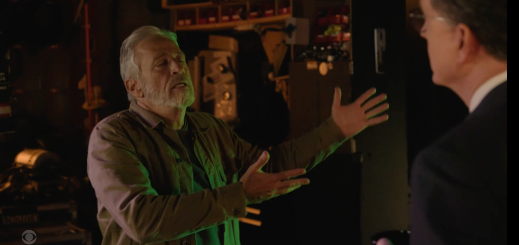 Two men talking, one gesticulating with his hands.