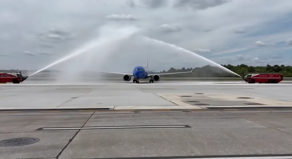 A Southwest Airlines Boeing 737 MAX 8, carrying Jon Jackson, goes under a water cannon salute after arriving at BWI on May 2, 2026.