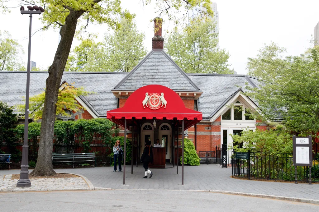 Exterior of Tavern on the Green restaurant in Central Park, featuring a red awning and brick facade.