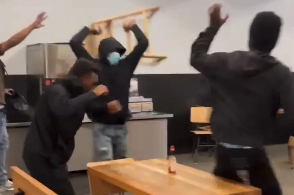 Four young men with raised hands and fists.