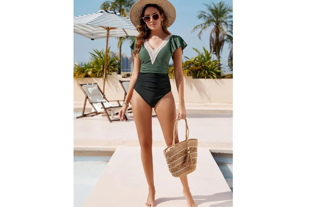 A woman in a modest swimsuit with flutter sleeves and color blocking.
