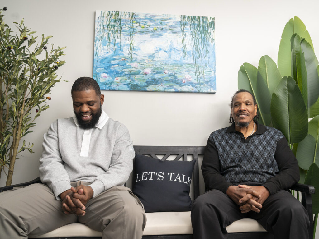 These grandparents sit on benches, ready to talk to strangers who need them