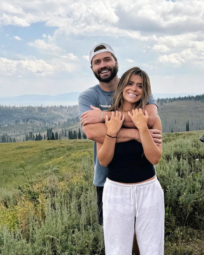 Taylor Frankie Paul embracing Dakota Mortensen, smiling in a mountainous outdoor setting.
