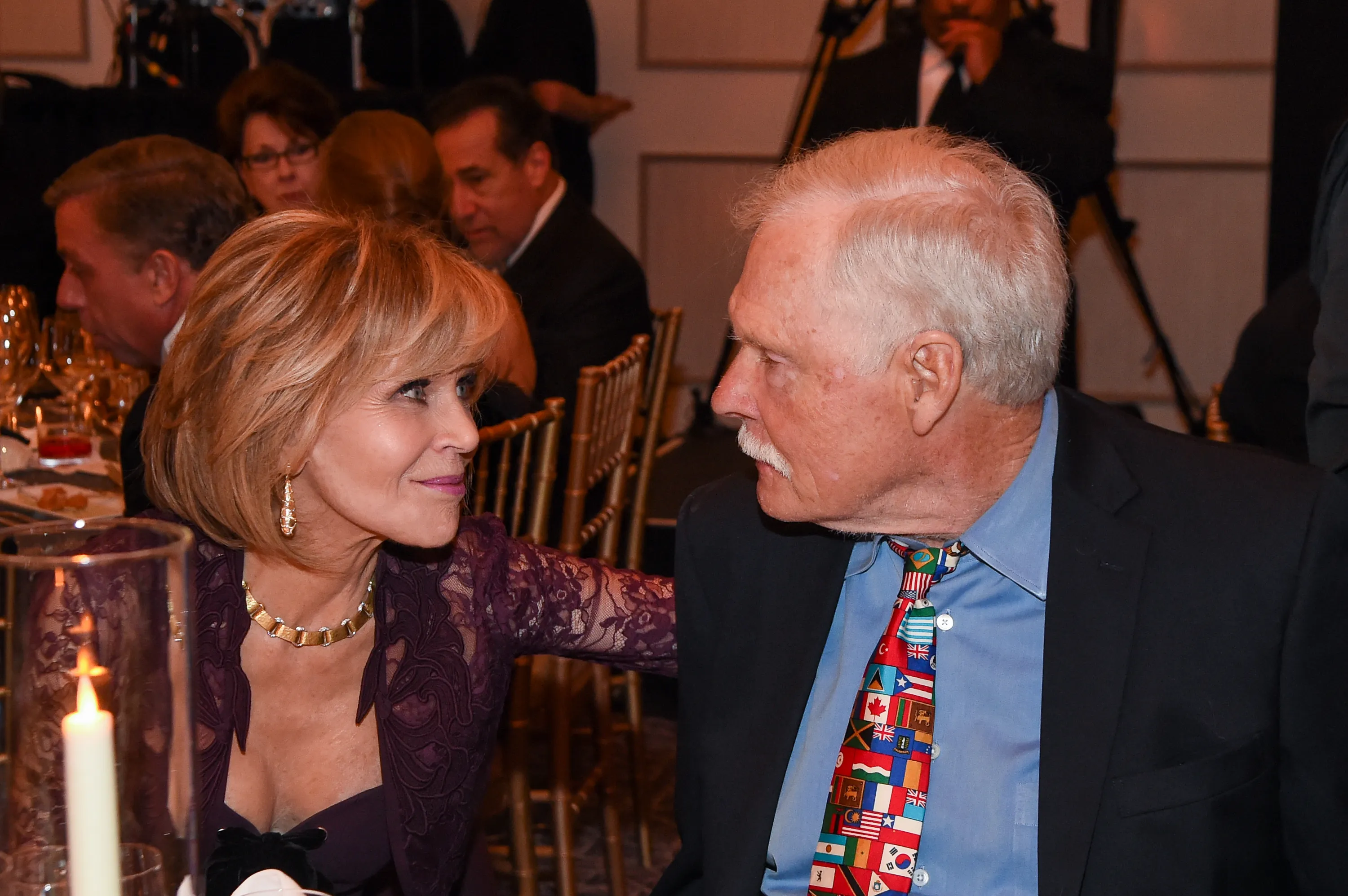 Jane Fonda and Ted Turner looking at each other at a formal event.