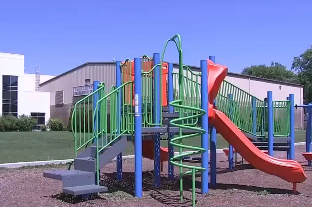 Playground equipment with a slide and climbing structures at Roesner Park.