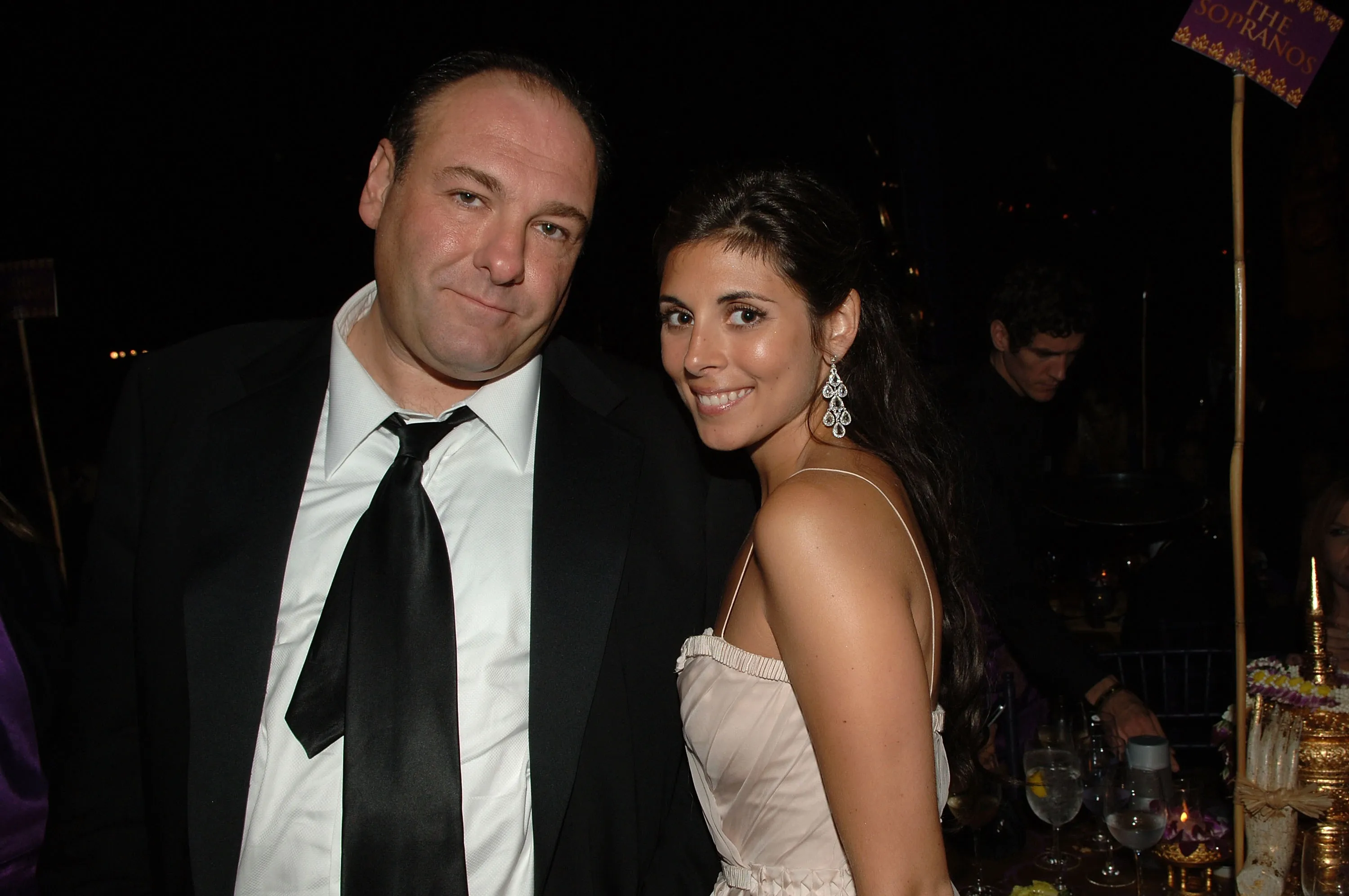 Actors James Gandolfini and Jamie-Lynn Sigler posing at an event.