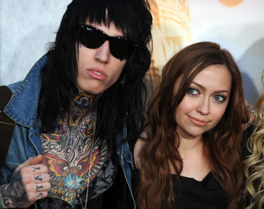 Trace Cyrus wearing sunglasses and Brandi Cyrus with a nose ring at the premiere of 