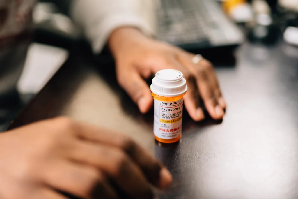 The physician allegedly wrote fraudulent prescriptions for highly addictive medications without ever examining patients, while his son found buyers and collected payments as part of the scheme.