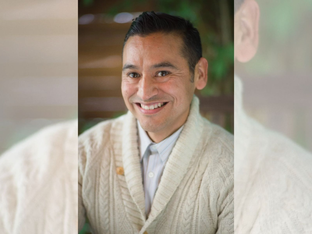Close-up photo of Alberto Rangel smiling.