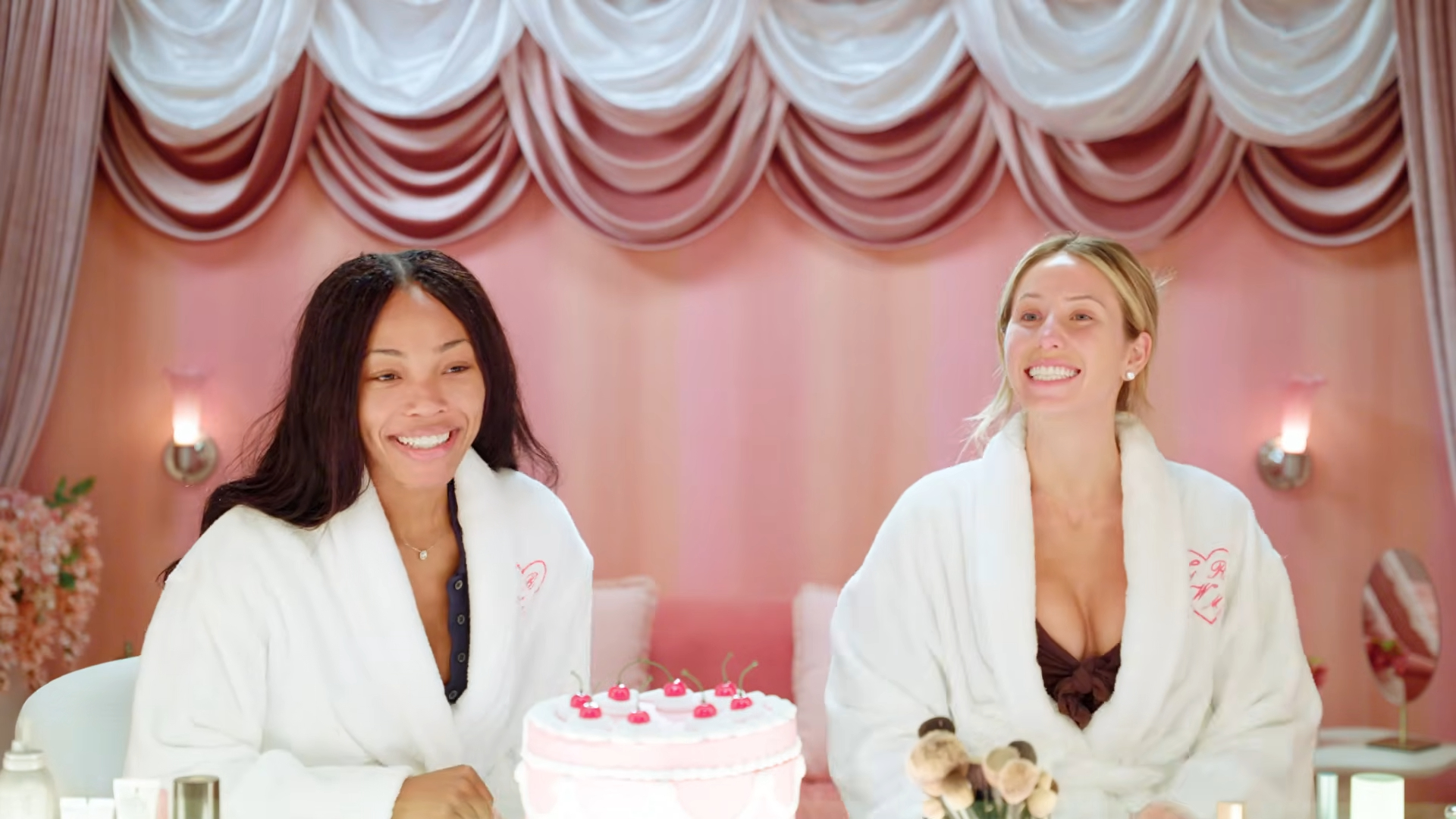 Alix Earle and Quenlin Blackwell in white robes, smiling as they discuss dating.