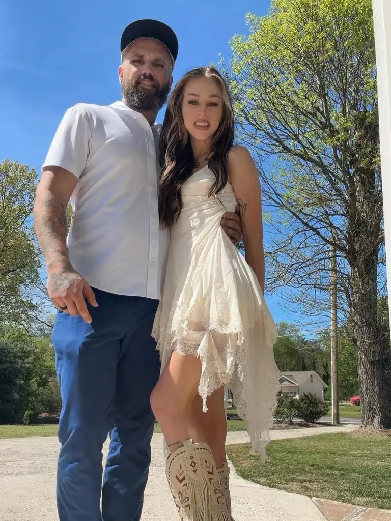 Amanda Conner posing with her husband Ryan Edwards outdoors.