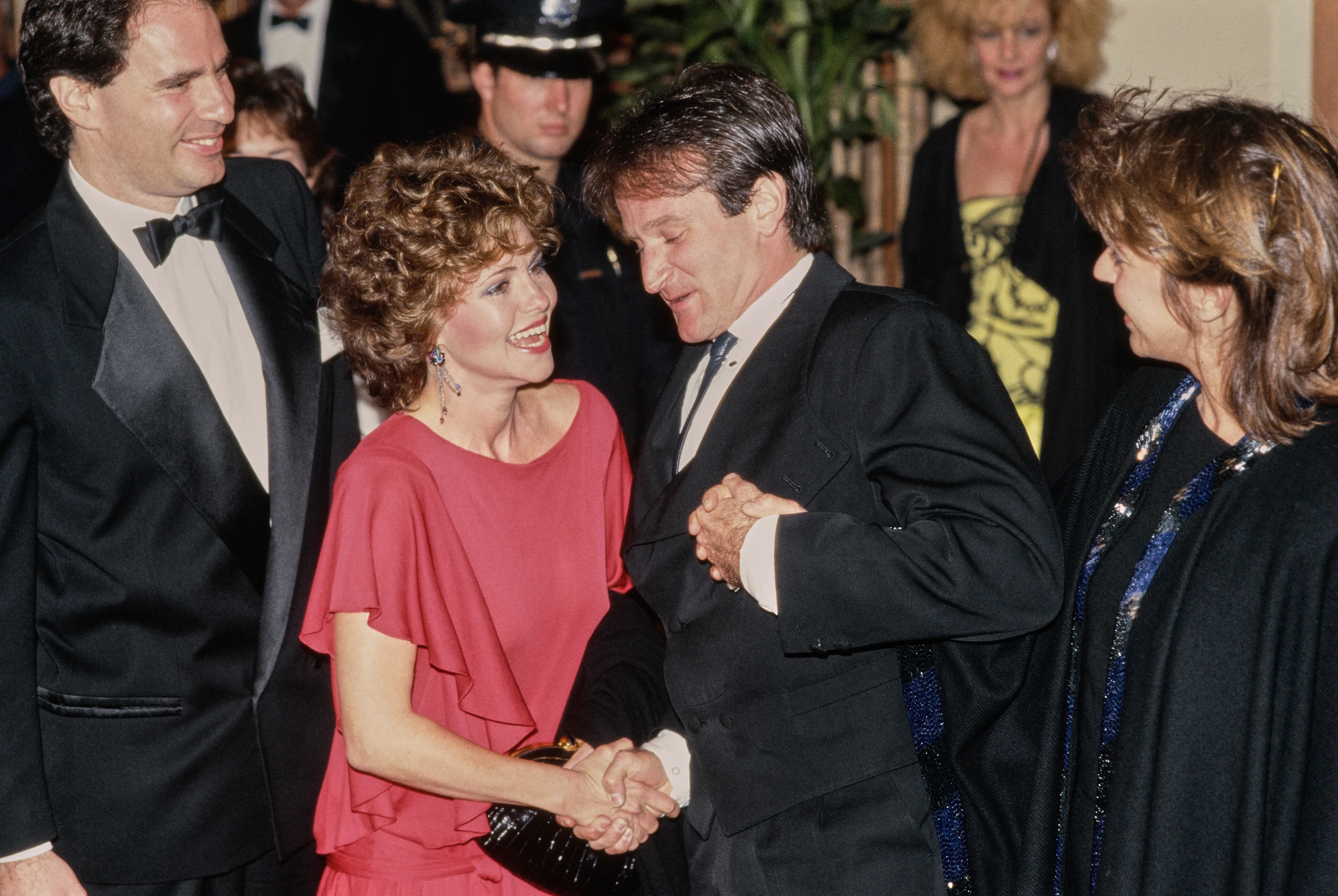 Sally Field shakes hands with Robin Williams at the 42nd Golden Globe Awards.
