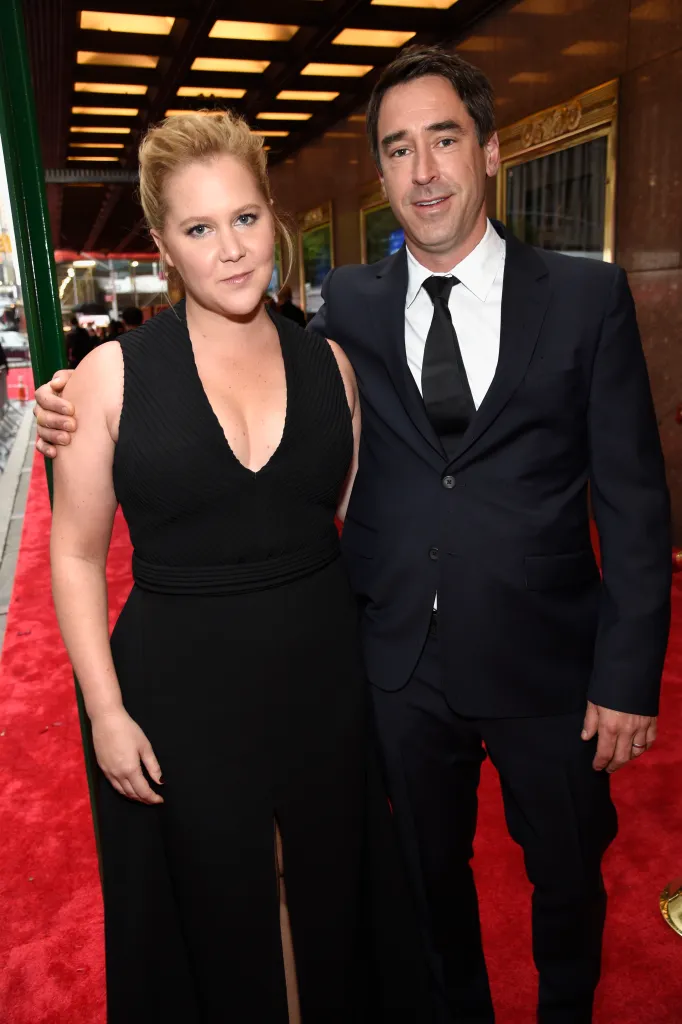 Amy Schumer and Chris Fischer on a red carpet.