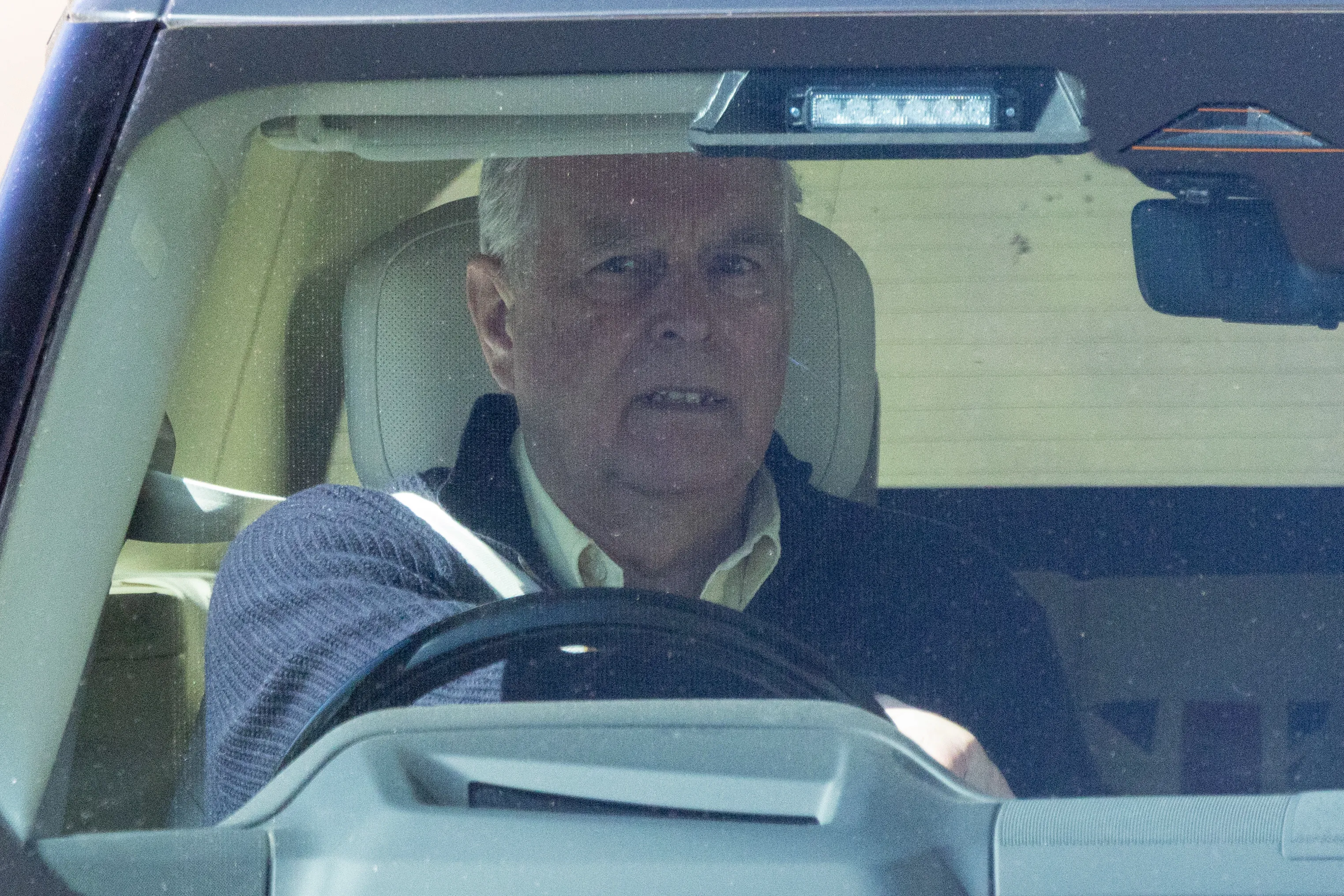 Andrew Mountbatten Windsor driving a vehicle.