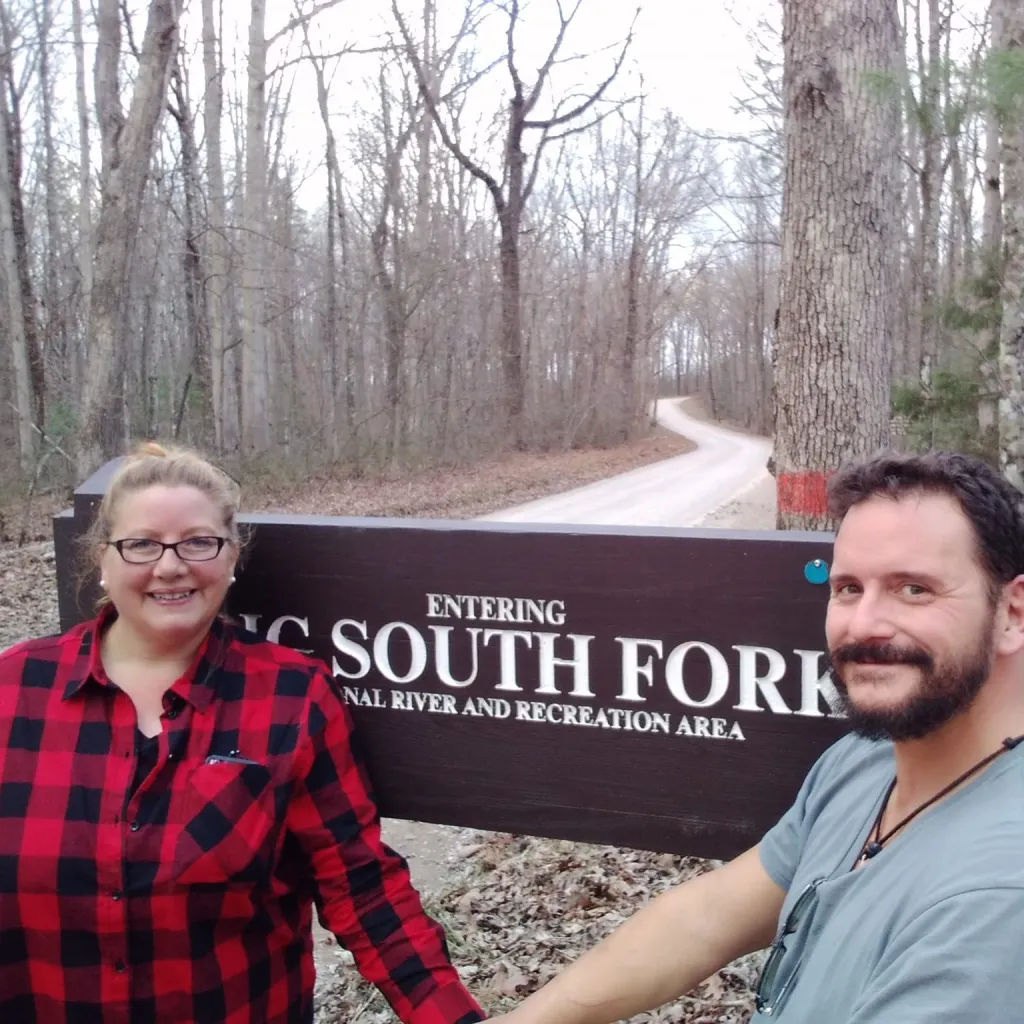 Anissa Osborne and Christopher Osborne in front of an 