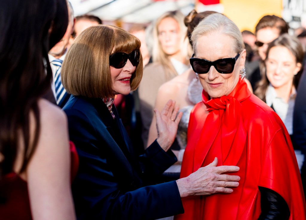 Anna Wintou, in a black coat,r and Meryl Streep, in a red cloak, at the world premiere of 