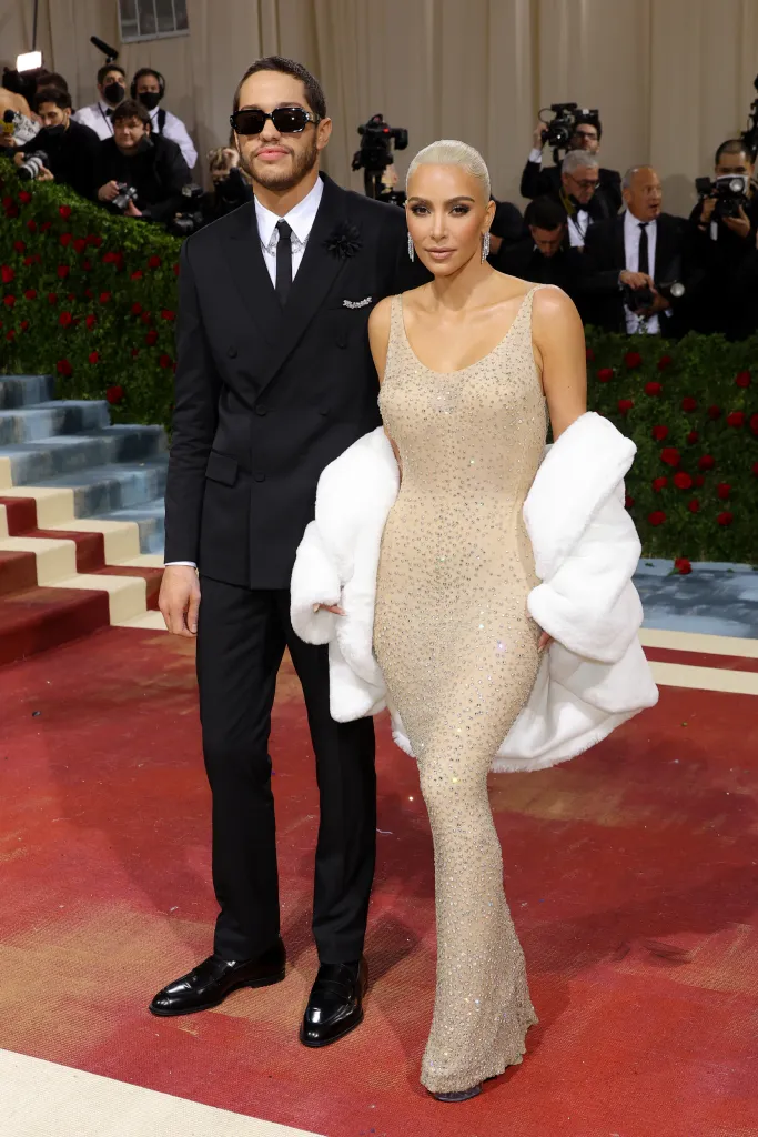 Pete Davidson and Kim Kardashian posing on a red carpet at the Met Gala.