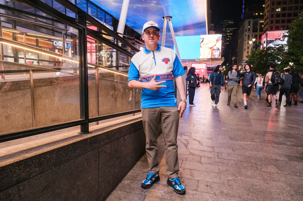Antonio Borjas, a Knicks fan, poses in a vintage polo and Kith NB Knicks shoes outside Madison Square Garden.