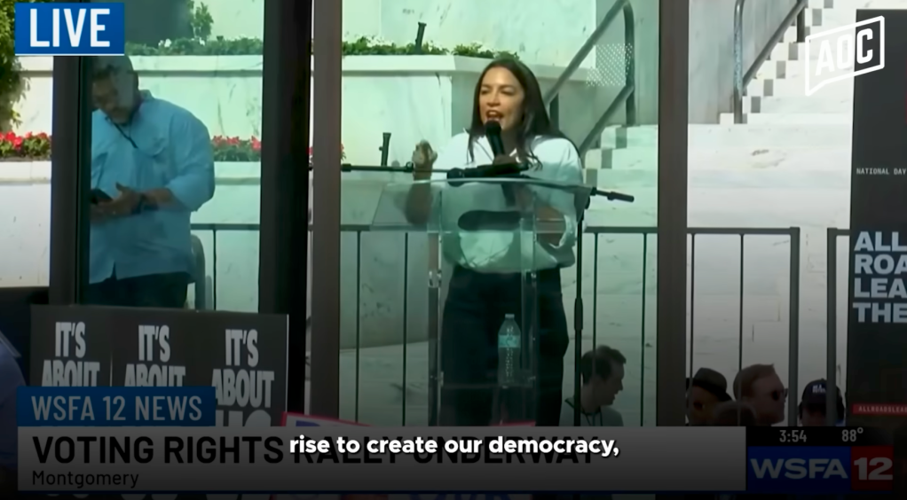 Congresswoman Alexandria Ocasio-Cortez speaking at a rally about voting rights.