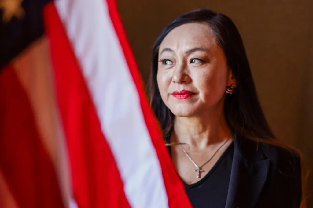 Arcadia council member Eileen Wang looking to the left with an American flag partially visible.