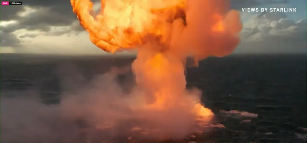 A large orange explosion over the ocean during the SpaceX Starship Flight 12 launch.