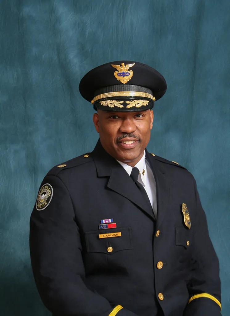 Atlanta Deputy Chief Kelley Collier in uniform, smiling faintly in front of a blue background.