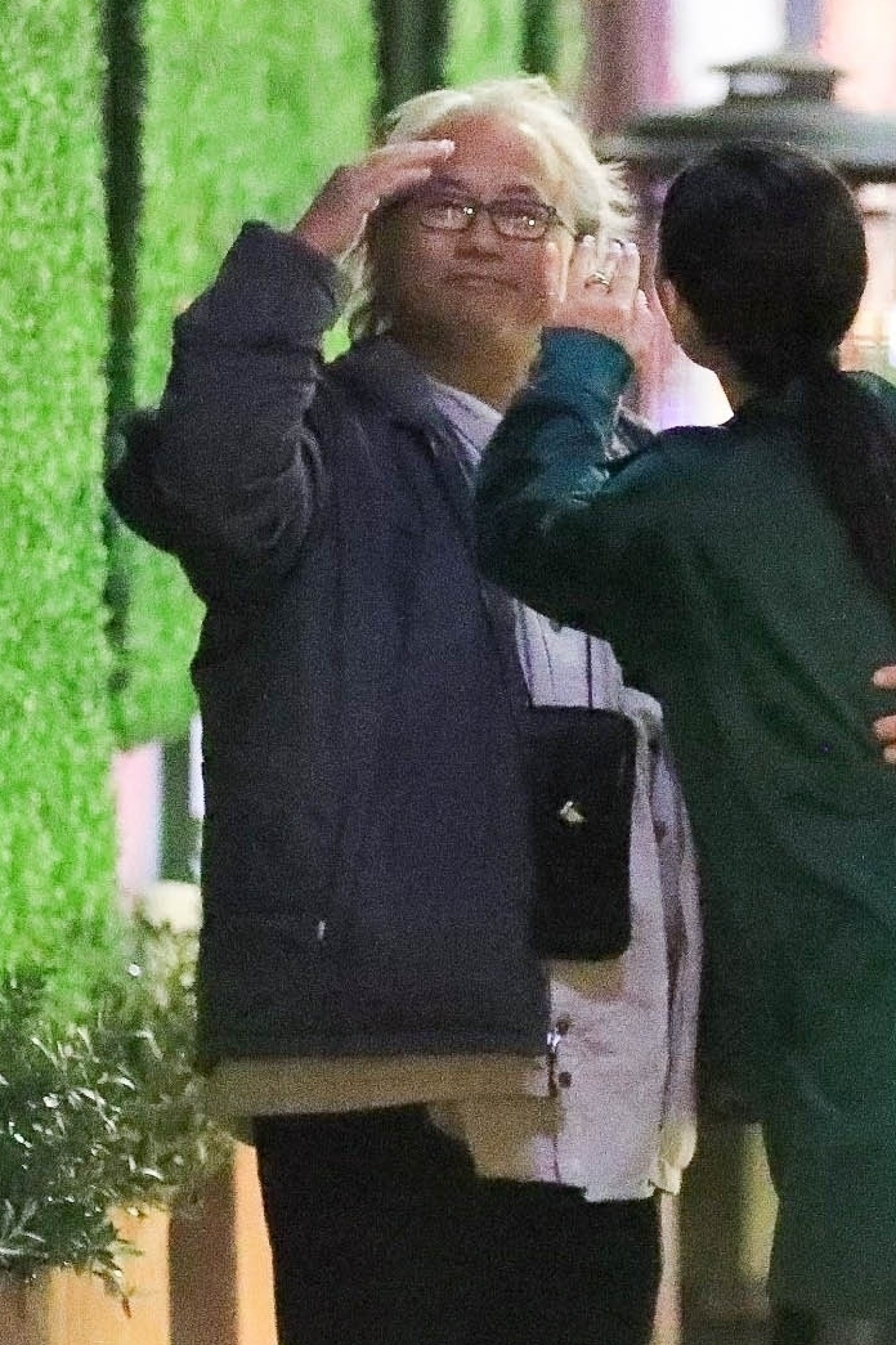 Kenneth Iwamasa salutes while Matthew Perry is partially visible.