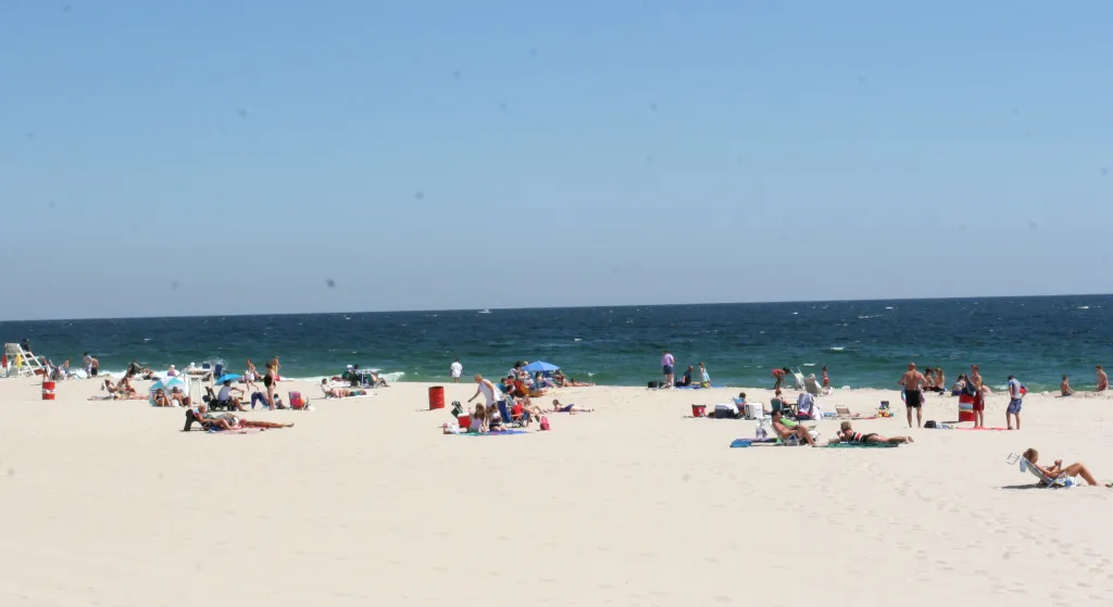 The beach at Belmar, New Jersey, with people sunbathing and swimming.