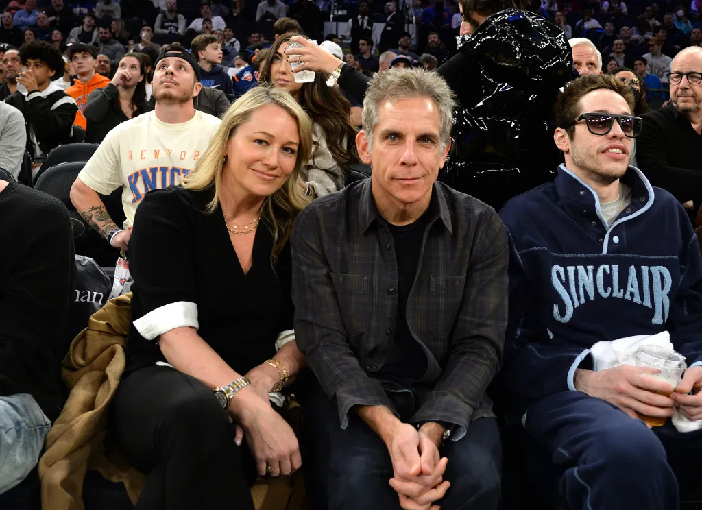 Ben Stiller, Christine Taylor, and Pete Davidson attending a basketball game.