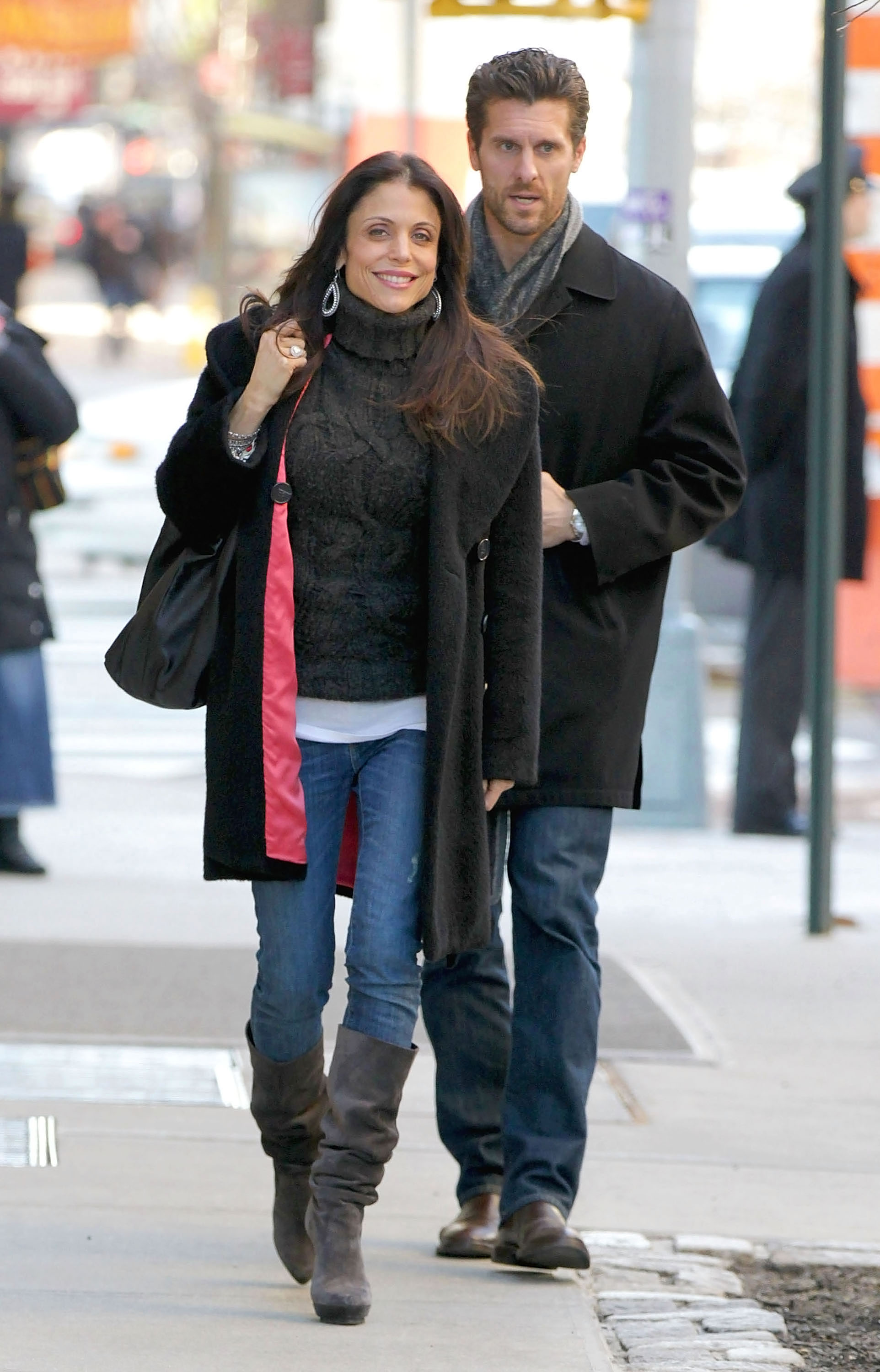 Bethenny Frankel and her husband Jason Hoppy walk on a city street.