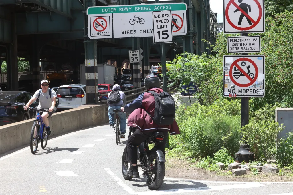 Cyclists and e-cyclists on the Queens side of the Queensboro Bridge following a fatal accident.