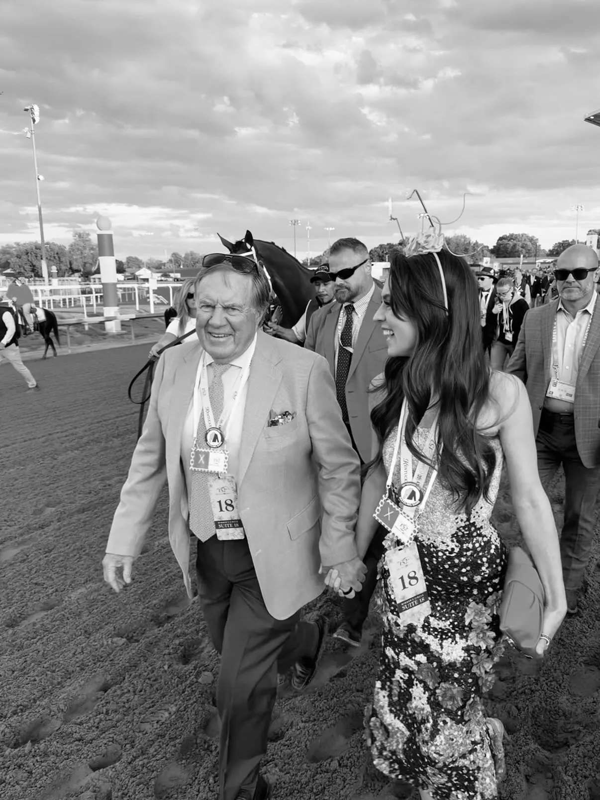 Bill Belichick and Jordon Hudson holding hands at the Kentucky Derby.