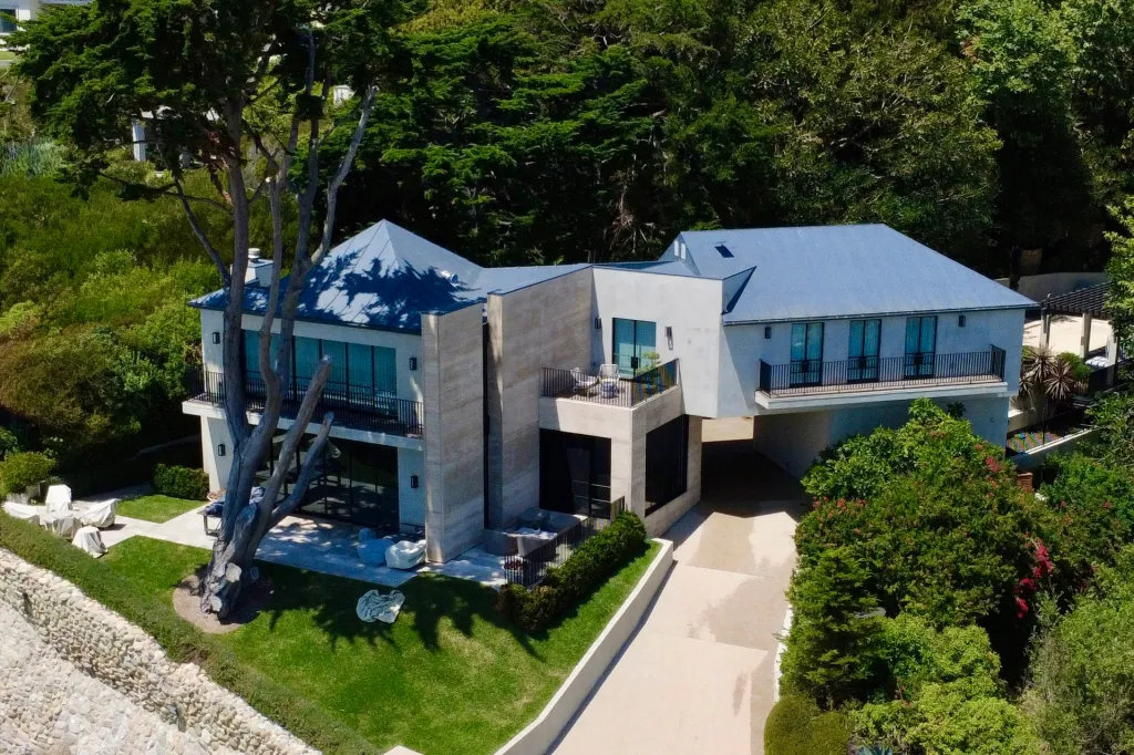 Aerial view of Daniel Nadler's Malibu mansion with a gray roof and numerous windows.