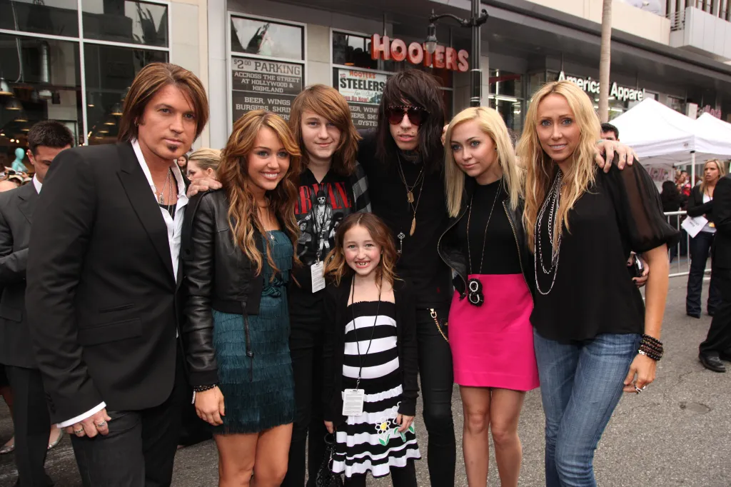 The Cyrus family poses together on the red carpet at the premiere of 