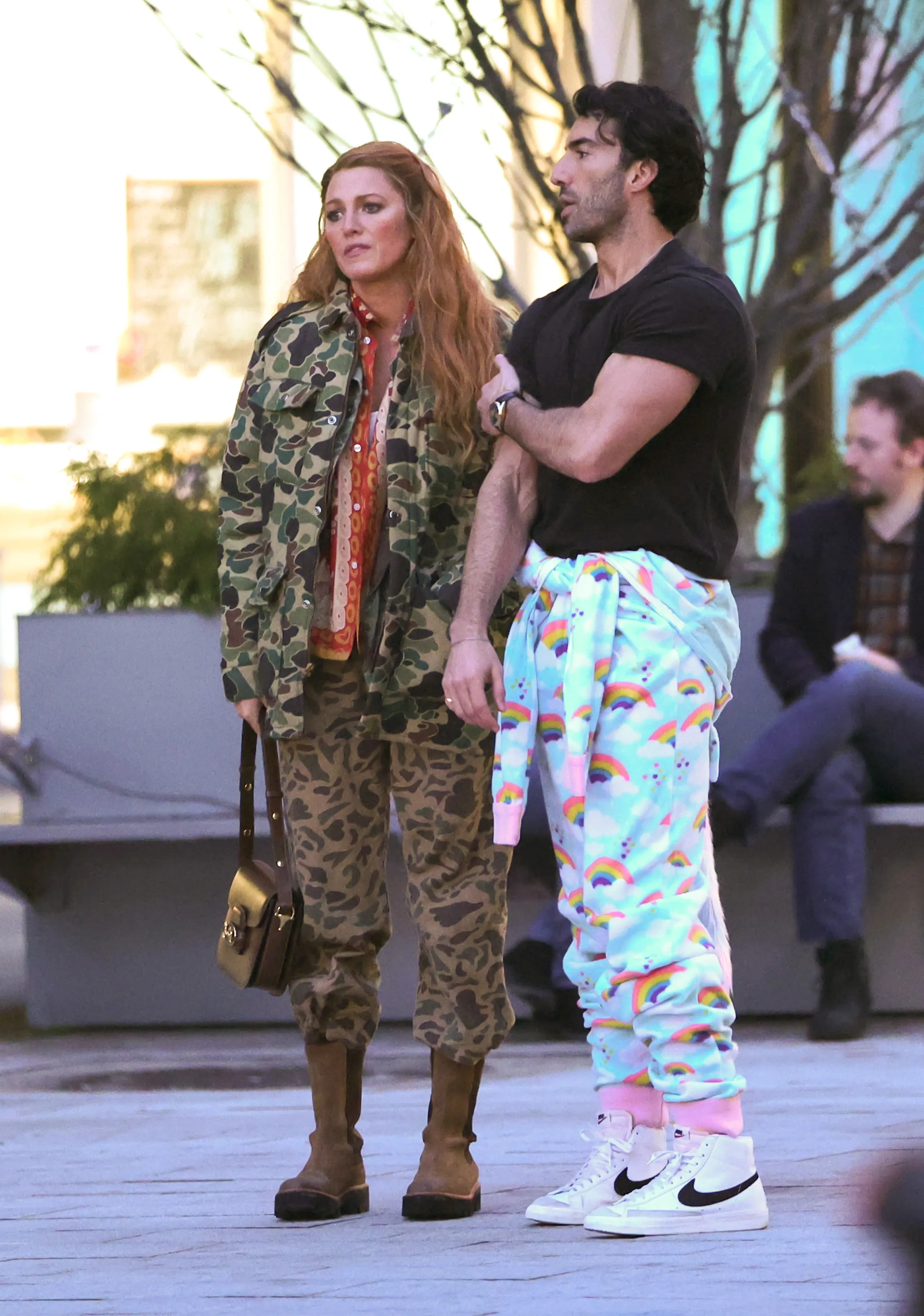 Blake Lively in a camouflage outfit and Justin Baldoni in rainbow pajamas on the set of 