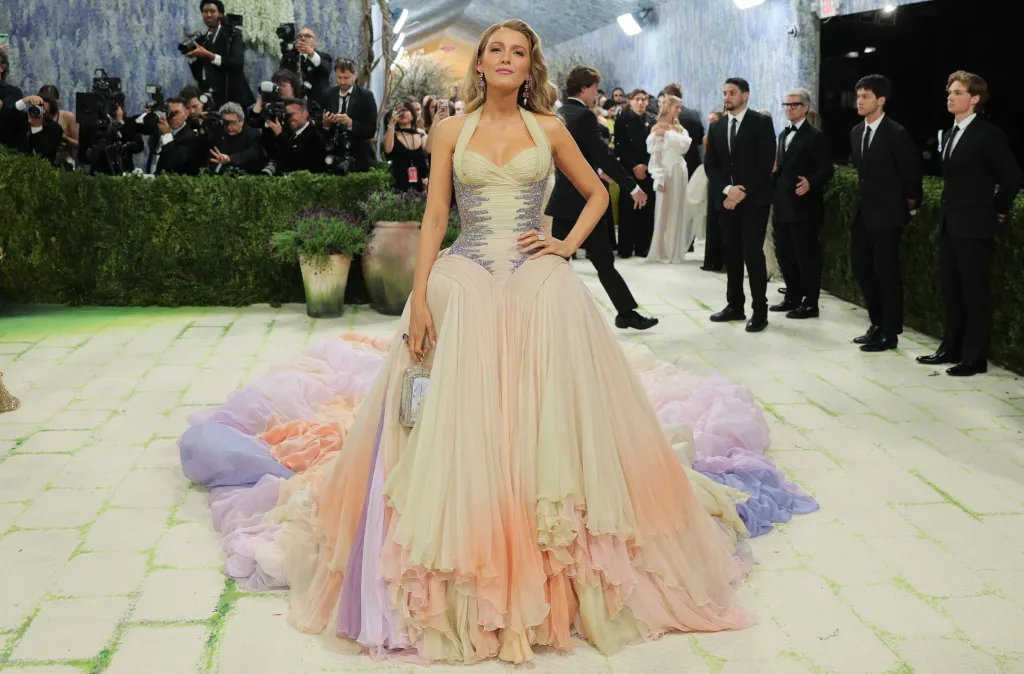 Blake Lively poses in a colorful gown with a beaded bodice and flowing skirt at the Met Gala.