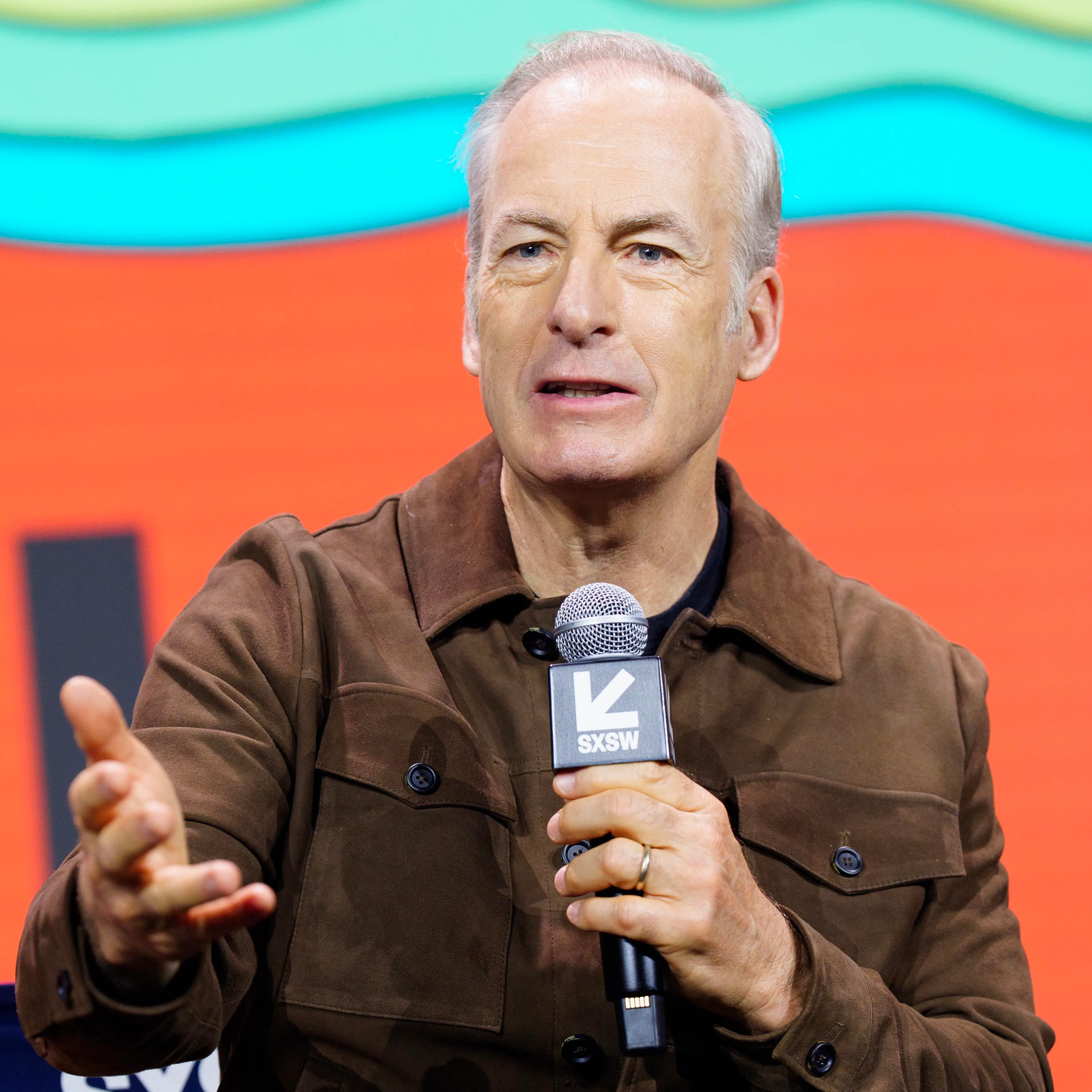 Bob Odenkirk speaking on stage at the SXSW Conference.
