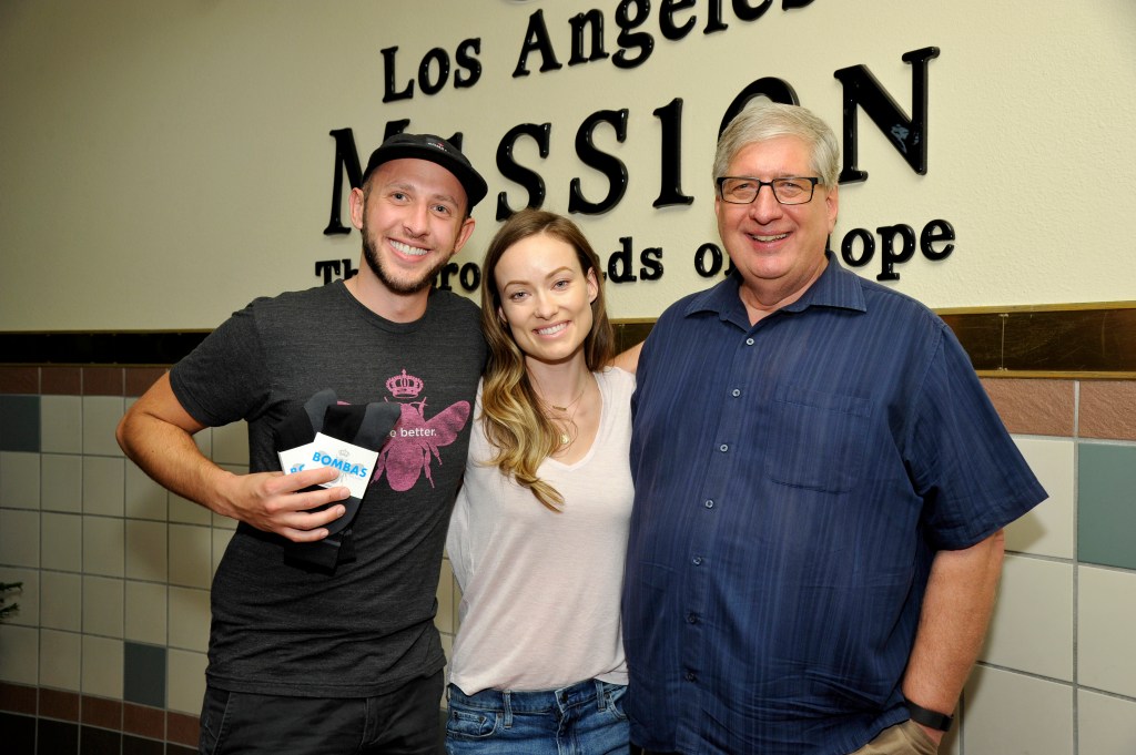 Bombas co-founder and CEO David Heath, actress Olivia Wilde, and Los Angeles Mission President Herb Smith at the Los Angeles Mission.