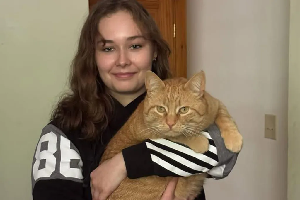 Breanne Keane holding her orange cat.