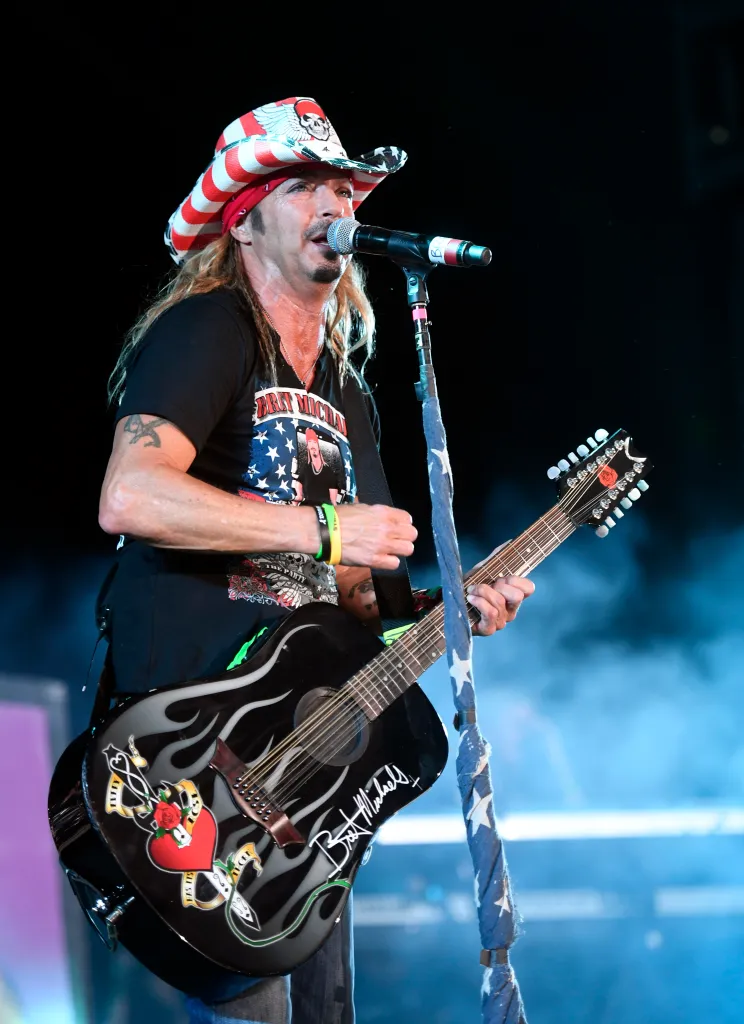 Bret Michaels performing onstage with his custom guitar.