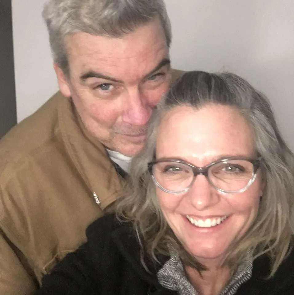 Brian Hooker and wife Lynette Hooker smiling together in a selfie.