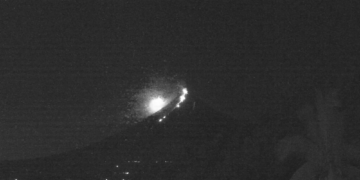 Bright Green Fireball Meteor Streaks Past Erupting Volcano in Stunning Video