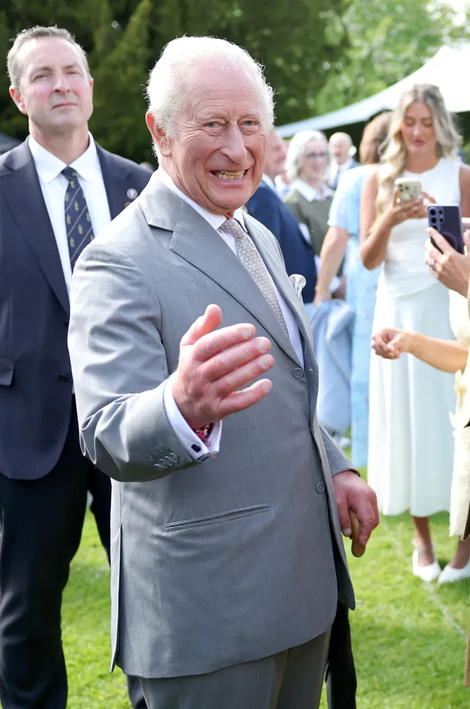 King Charles III speaking with military personnel at Hillsborough Castle.