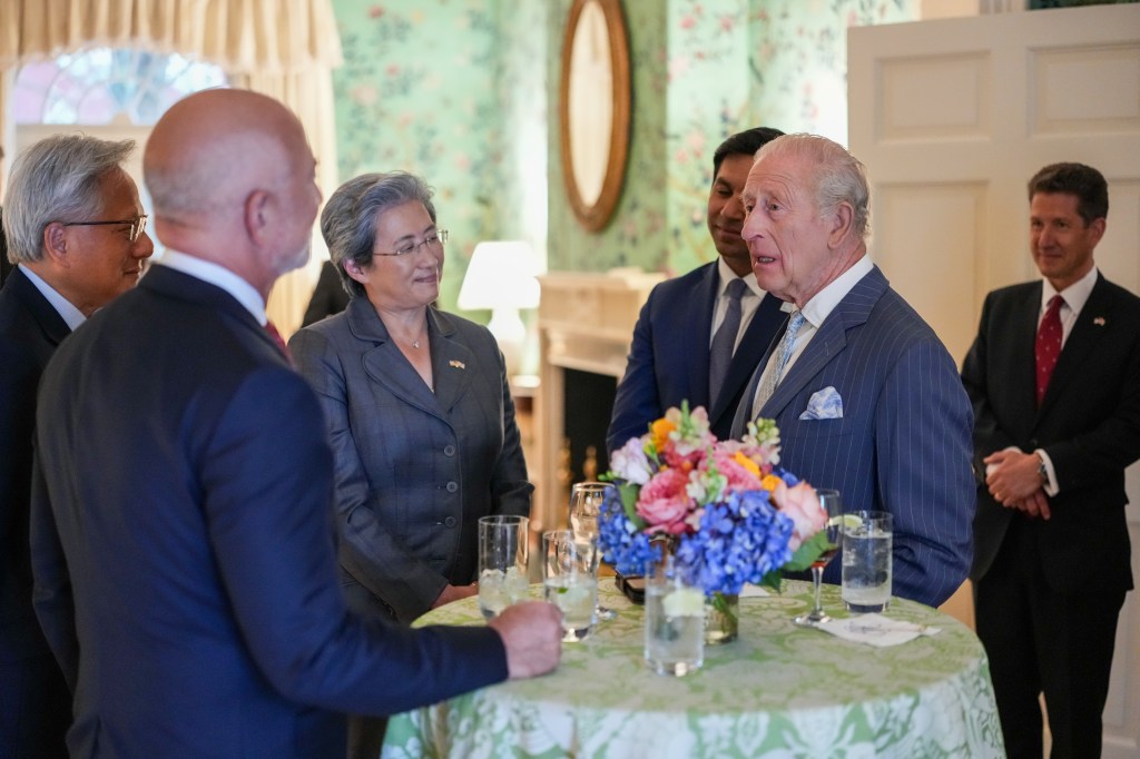 Britain's King Charles III, in a grey suit, speaks with Nvidia CEO Jensen Huang, Amazon founder Jeff Bezos, in a blue suit, and AMD President Lisa Su at Blair House.